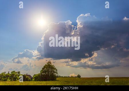 Blue sky with clouds and sun rays, dreamy landscape Stock Photo