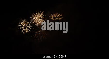Three fireworks in night sky. Stock Photo