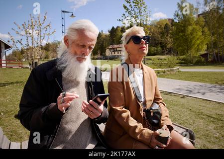 Couple relaxing on bench Stock Photo
