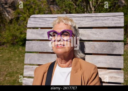Woman sunbathing with eyes closed Stock Photo
