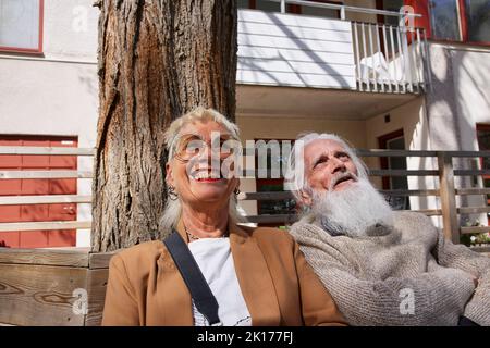 Smiling couple sitting together Stock Photo