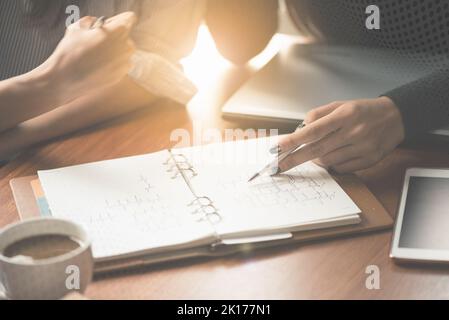 Team work process. young business managers crew working with new startup project. labtop on wood table, typing keyboard, texting message, analyze grap Stock Photo