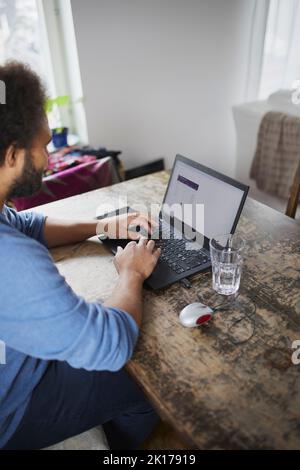 Man working on laptop from home Stock Photo