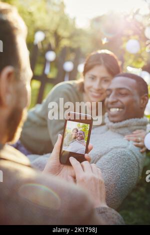 Hand with cell phone taking picture Stock Photo