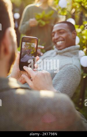 Hand with cell phone taking picture Stock Photo