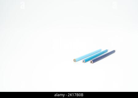 blue wooden colored pencils on a white background with end part in focus Stock Photo