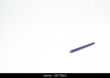 Purple wooden colored pencil on a white background with end part in focus Stock Photo