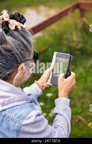 Senior woman using smart phone Stock Photo