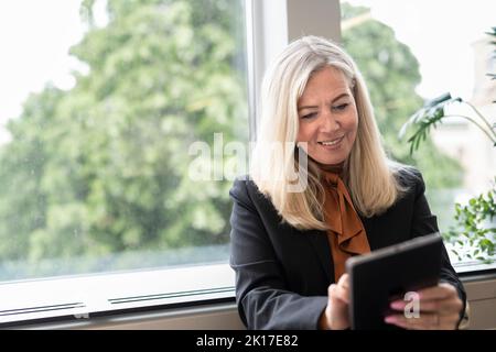 Smiling businesswoman using digital tablet Stock Photo