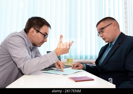 business people and lawyers discussing contract sitting at the table. man chief is signing papers. Business communication in the office. Hiring an emp Stock Photo