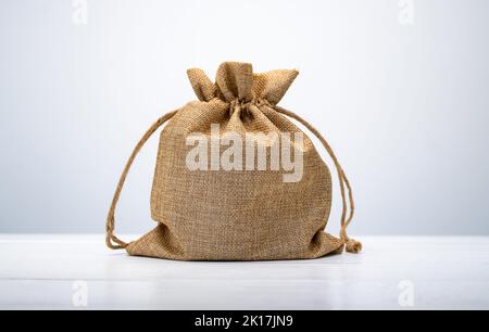 Burlap bag on white table Stock Photo