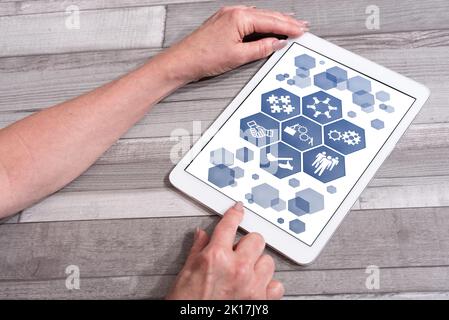 Teamwork concept shown on a tablet used by a woman Stock Photo