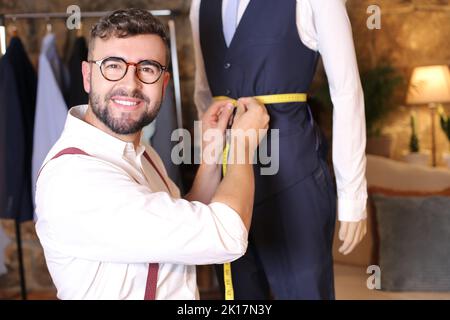 Male fashion designer taking some measurements Stock Photo - Alamy
