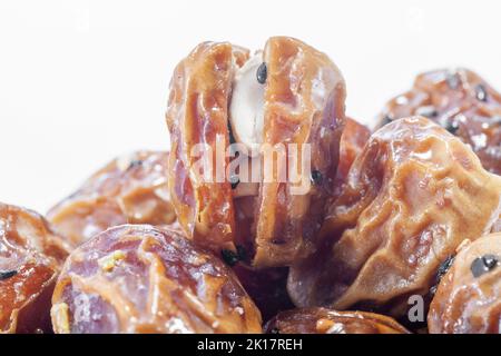 Traditional Arabic Sukari dates close up with nuts and arab herbs  full frame as background Stock Photo