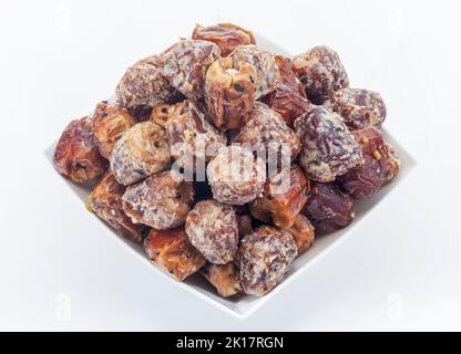 Traditional Arabic Sukari dates close up with nuts and arab herbs  full frame as background Stock Photo