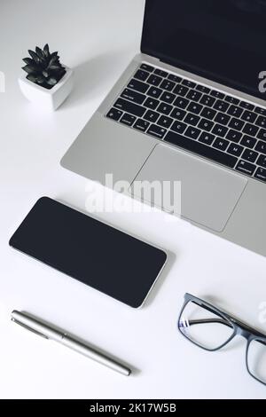 Digital business ideas. Online Business. Modern workspace with blank screen laptop, cell phone, pencil, on white work table Stock Photo