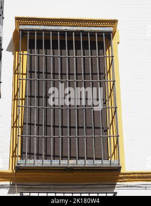 Typical old Andalusian large window with metal bars Stock Photo