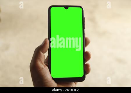A guy is catching a phone , Phone green screen , man using a phone green screen Stock Photo