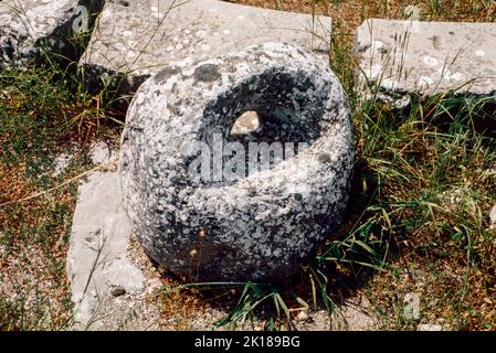 Stone weight in Roman Baths at Epidaurus - a small city (polis) in ancient Greece, on the Argolid Peninsula at the Saronic Gulf, best known for its ancient Greek sanctuary. March 1980. Archival scan from a slide. Stock Photo