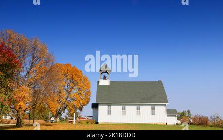 October 10, 2020, MAQUOKETA, IOWA, USA: Emeline Schoolhouse in Brandon Township of Jackson County, Iowa located at 14353 50th Ave, Maquoketa, Iowa. The building was used from 1848 until 1966 the school is just south of the SE corner of County Y34 and County E17..The structure is one of the few schools to have full basement made from quarried limestone, with two limestone pillars holding center beam..The cloak room on west end just inside the door, with two doors to the main school room..The wood frame and siding is now covered with metal. A â€œtray ceilingâ€ was added in later years to conser Stock Photo