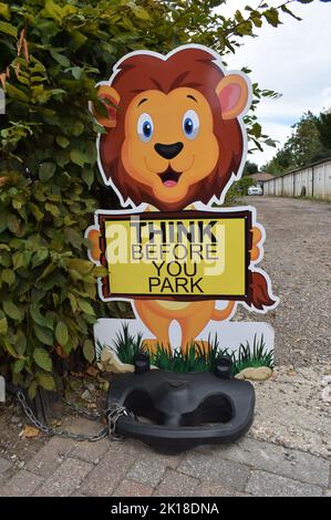 Sign near a school: "Think before you park". Stock Photo
