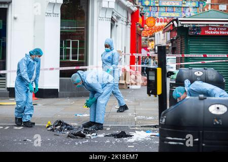 London, UK.  16 September 2022.  Forensics officers inspect evidence at a crime scene on Coventry Street, next to Leicester Square and Chinatown.  It has been reported that two police officers have been stabbed and are in hospital.  A man in his 20s has been arrested on suspicion of grievous bodily harm and assaulting an emergency worker in an incident that took place at 6am this morning.  Credit: Stephen Chung / Alamy Live News Stock Photo