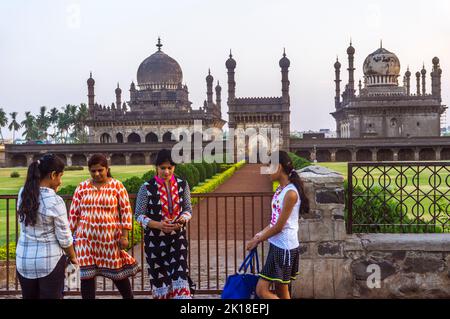 Bijapur, Karnataka, India : A group of young women stand next to the 17th century Ibrahim Rouza mausoleum and mosque considered as one of the most bea Stock Photo