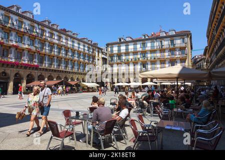 San Sebastian, Basque Country, Spain : Tourists seat at an open air cafe at Constitution Square in the Alde Zaharra old town. Stock Photo