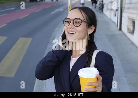 Businesswoman on the phone in city street Stock Photo