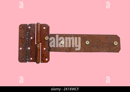 rusty metal door hinge. Door hinge isolated on pink background Stock Photo