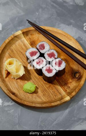 Different types of delicious and juicy sushi and rolls on a wooden board Stock Photo
