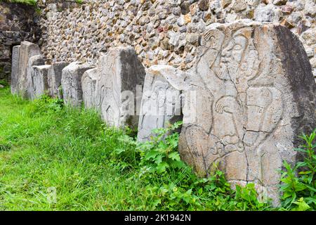 The famous Los Danzantes, carved stone monuments next to building L, Monte Alban Archeological site, Zapotec civilization ruins, Oaxaca, Mexico Stock Photo