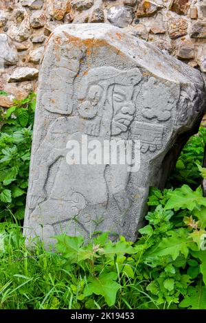 The famous Los Danzantes, carved stone monuments next to building L, Monte Alban Archeological site, Zapotec civilization ruins, Oaxaca, Mexico Stock Photo