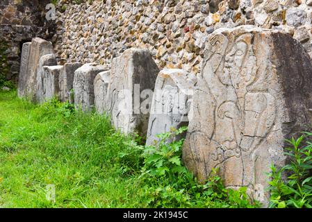 The famous Los Danzantes, carved stone monuments next to building L, Monte Alban Archeological site, Zapotec civilization ruins, Oaxaca, Mexico Stock Photo