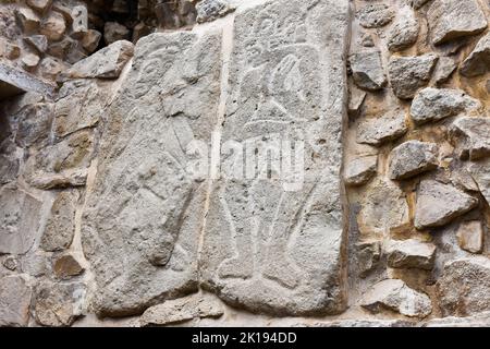 The famous Los Danzantes, carved stone monuments next to building L, Monte Alban Archeological site, Zapotec civilization ruins, Oaxaca, Mexico Stock Photo