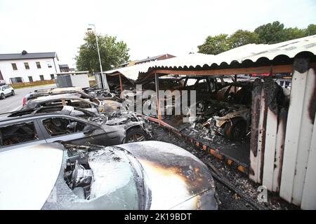 Police forensics on site, in Klockaretorpet in Norrköping, Sweden, where around 20 cars burned in a carport earlier on Wednesday. Stock Photo