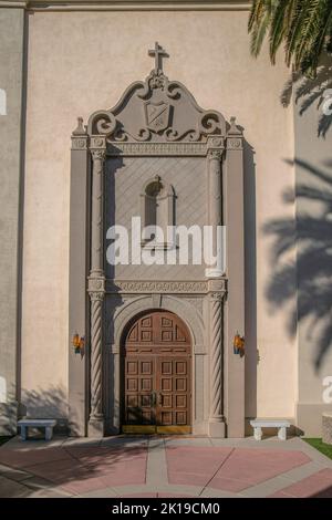 Wooden double door of a church with decorative stone doorframe at downtown Tucson, Arizona Stock Photo