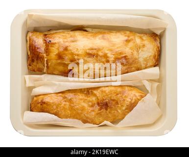 Baked strudel with apple filling in a rectangular pan isolated on white background, top view Stock Photo