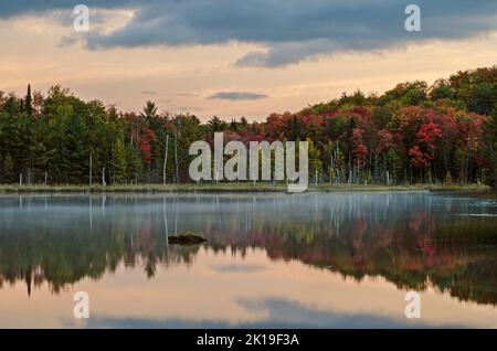 Autumn color starts to grow in ernest in early October on the shores of Council Lake in the Hiawatha National Forest in Alger County, Michigan Stock Photo