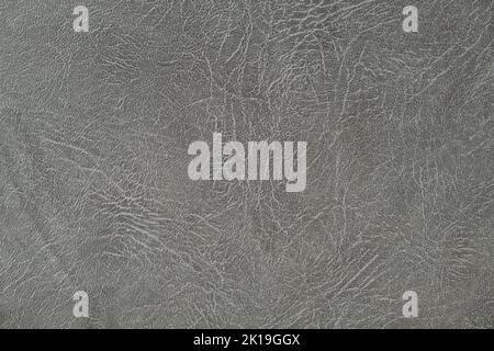 The texture of artificial leather. Background of black leather with patterns. Artificial material made of gray leather. Stock Photo
