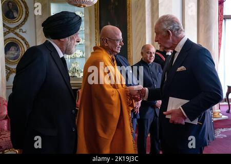 RETRANSMITTING ADDING ADDITIONAL INFORMATION King Charles III shakes hands with Chief Sangha Nayaka of Great Britain, Head Monk of the Vihara Ven Bogoda Seelawimala Nayaka Thera, during a reception with faith leaders at Buckingham Palace, London. Picture date: Friday September 16, 2022. Stock Photo