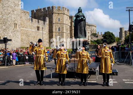 Crowds sang the national anthem and gave three cheers for King Charles III during a proclamation ceremony in Windsor at the Queen Victoria statue. Stock Photo