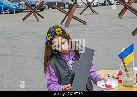 Dnipro, Ukraine - September 10, 2022: Little artist paint metal anti-tank obstacle czech hedgehog in front-line city during the russian-Ukrainian war Stock Photo