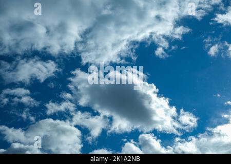 Blue sky with thunderclouds. The sun breaks through the clouds. Black clouds. Stock Photo