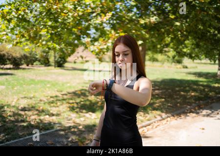 Young sportsman checking pulse on smart watch Stock Photo