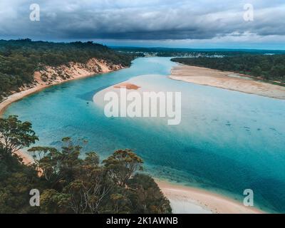 Storm clouds loom over the coastal tidal inlet Stock Photo