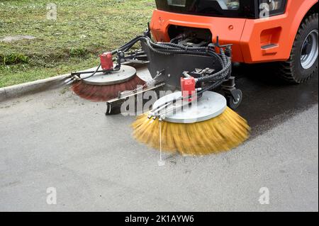 A special machine sweeps city paths Stock Photo