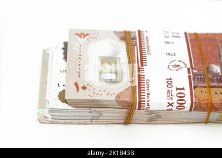 selective focus of stack of new Egyptian money banknotes currency of different values with rubber bands isolated on white background, pile of new poly Stock Photo