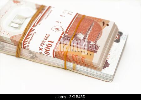 selective focus of stack of new Egyptian money banknotes currency of different values with rubber bands isolated on white background, pile of new poly Stock Photo