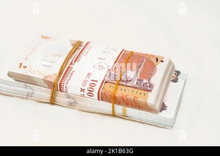 selective focus of stack of new Egyptian money banknotes currency of different values with rubber bands isolated on white background, pile of new poly Stock Photo